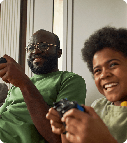 Happy father and child playing video games together